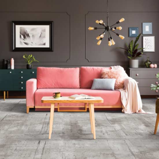 grey carpet in living room with pink couch
