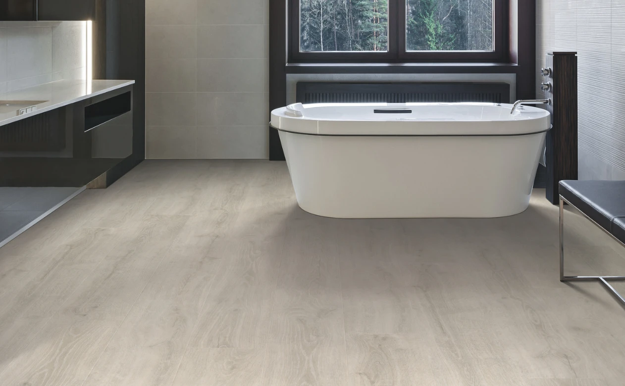 Light wood-look laminate flooring in a bathroom with a bathtub